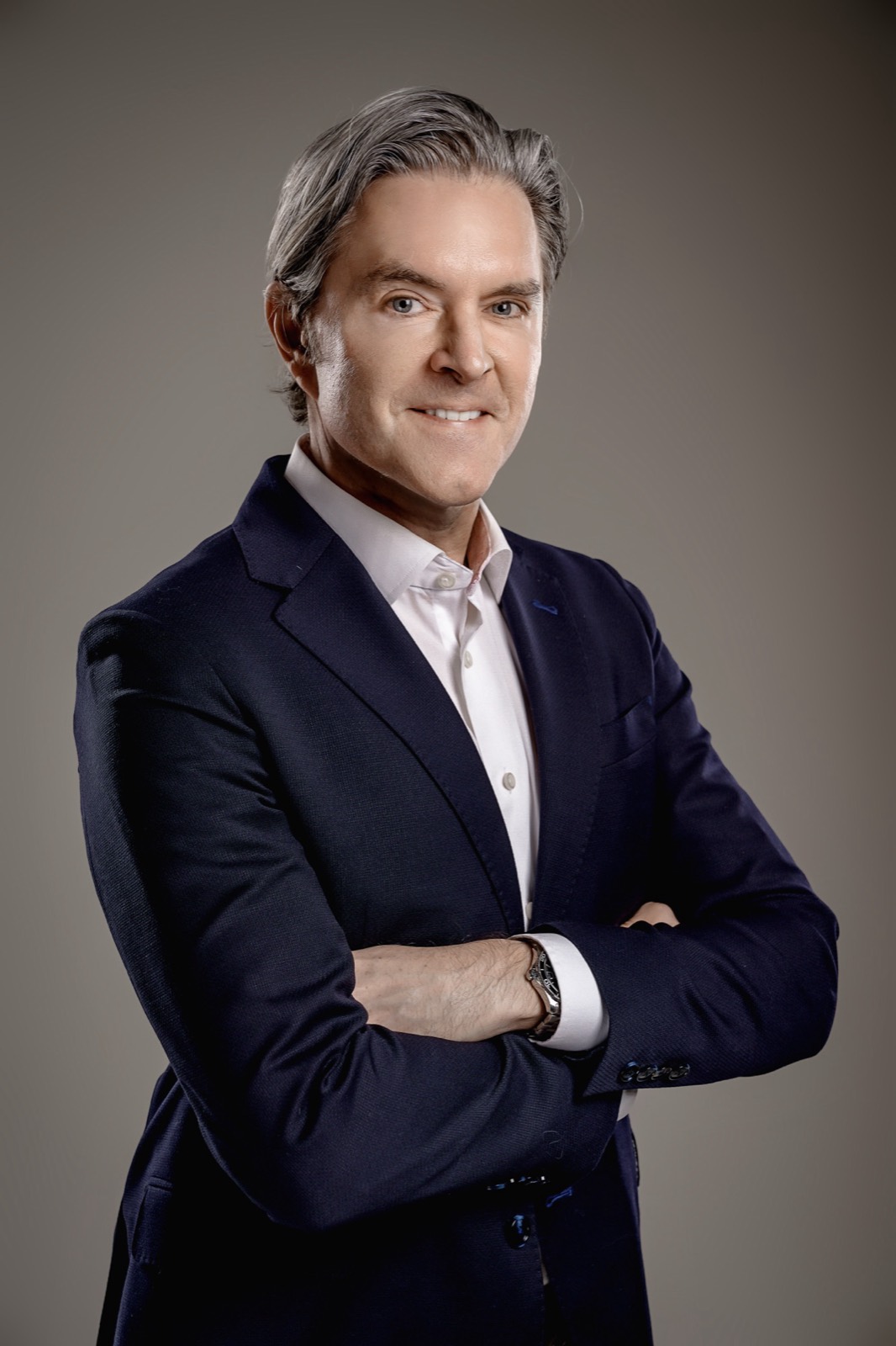 Matt Fraleigh in a navy jacket, arms folded